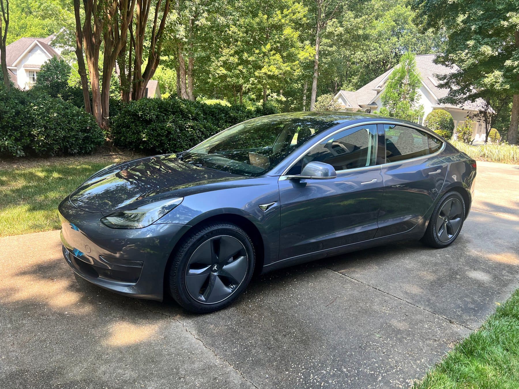 Gray Tesla Model 3 with fresh paint gloss after an exterior detail